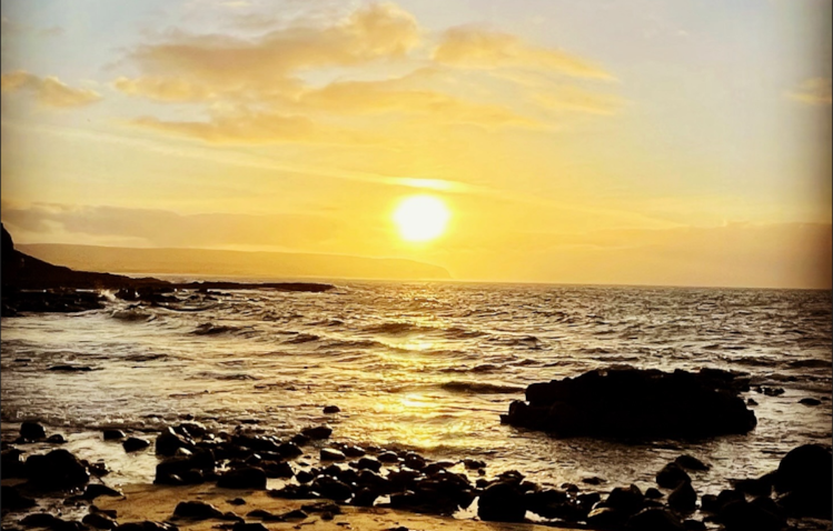 Yellow Sunset on a silhouetted beach